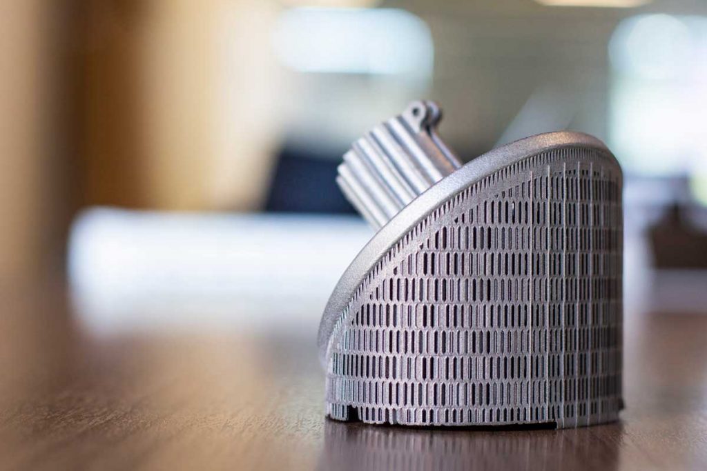 Metal support structures on an aluminum DMLS 3D printed part.