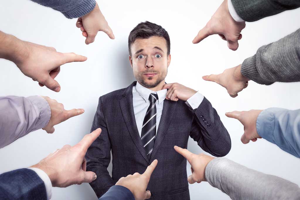 criticism-at-work fingers pointing at a man in business suit