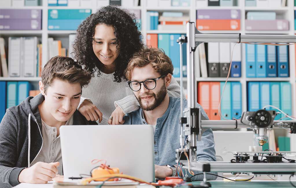 laptops for engineering students: students working with laptop and 3d printer
